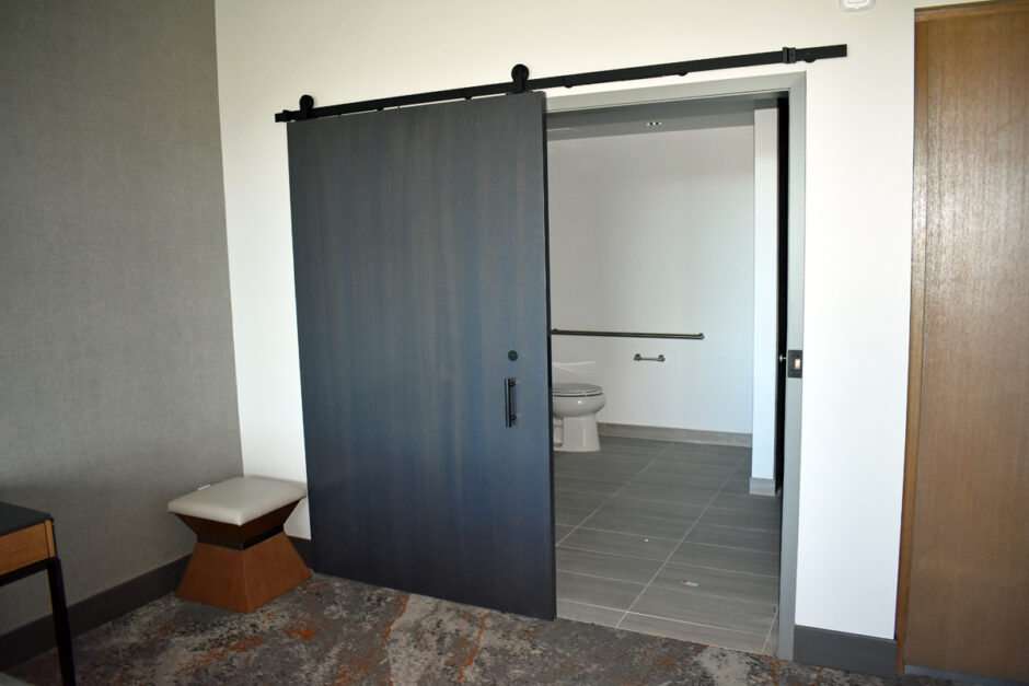 Some of the guest rooms include barn door casing. Here is a guest room on the top floor.